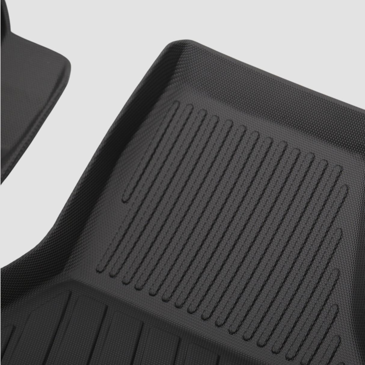 Detalj av svart 3D All Weather-mattset med räfflor för bilens bagageutrymme.