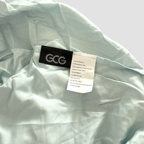 Ljusblå GCG MAX bambuslakan med märken som visar tvättråd och produktinformation.