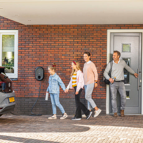 Familj anländer hem till Ratio laddbox och elbil, som är ansluten
