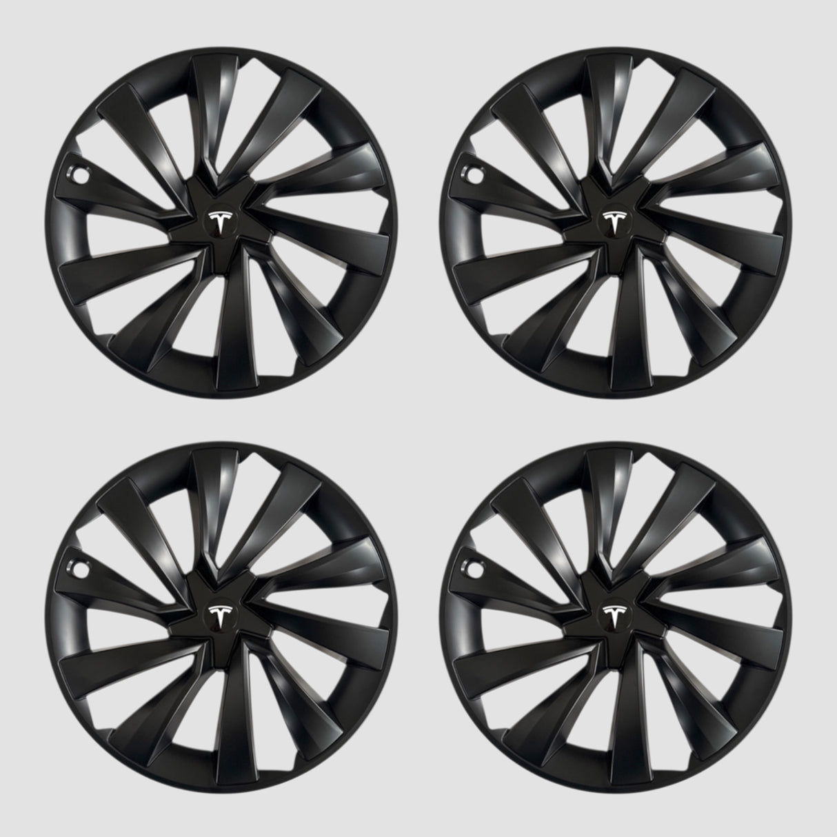 Fyra svarta MV Spiral hjulkapslar med Tesla-logotyp för Model Y 2025.